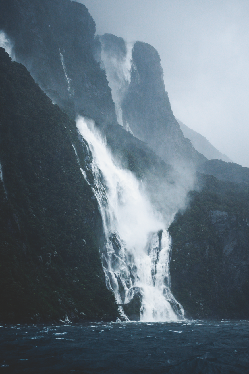 Milford sound spectacular green vertical cliffs waterfall